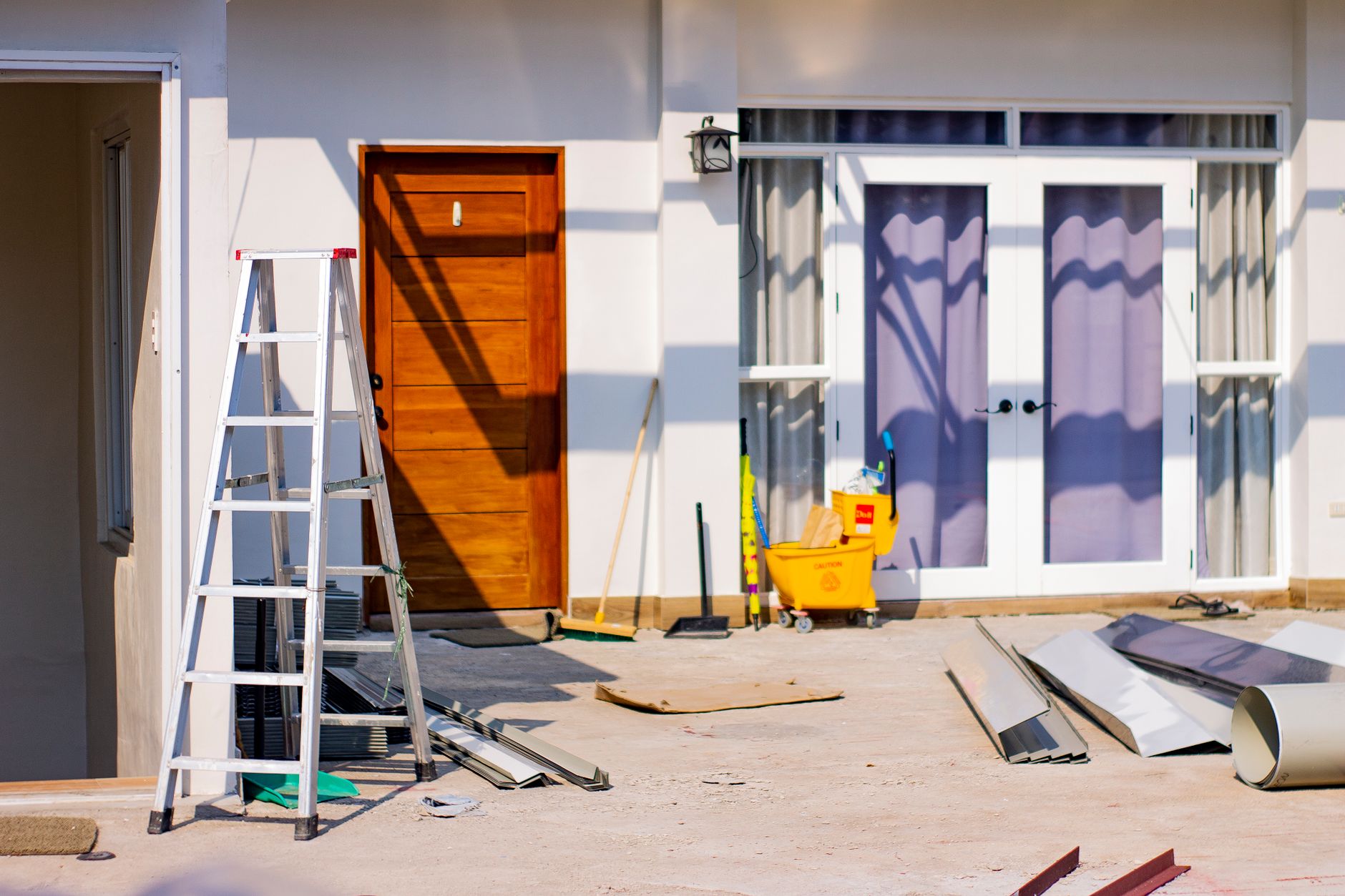 Exterior painter on ladder preparing GTA home